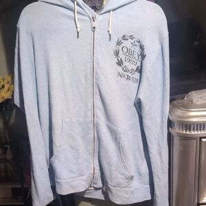 Obey Light Blue Zip-Up Hoodie Sweater with Crest